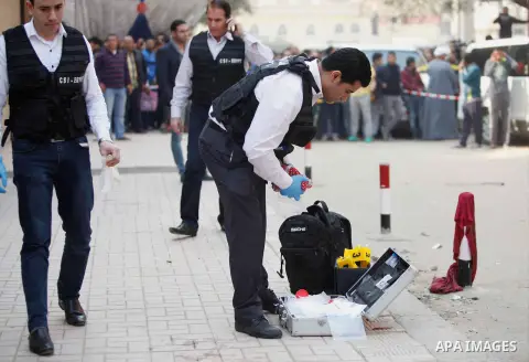 Egyptian forensic policemen inspect the site of a gun attack on Mar Mina church in Helwan district on the outskirts of Cairo, on December 29, 2017. A gunman opened fire on a church, killing at least nine people before po...