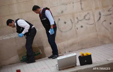 Egyptian forensic policemen inspect the site of a gun attack on Mar Mina church in Helwan district on the outskirts of Cairo, on December 29, 2017. A gunman opened fire on a church, killing at least nine people before po...