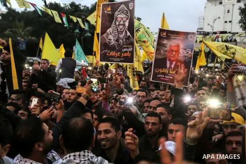 Palestinian supporters of the Fatah movement take part during a rally in Gaza City on December 31, 2017, marking the 53rd anniversary of the creation of the political party. Photo by Mohammed Dahman