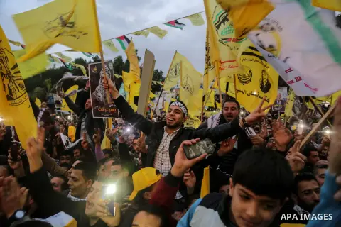 Palestinian supporters of the Fatah movement take part during a rally in Gaza City on December 31, 2017, marking the 53rd anniversary of the creation of the political party. Photo by Mohammed Dahman