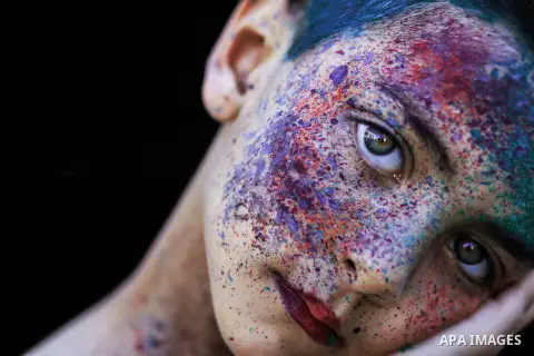 A portrait of a boy with colored face. Photo by Sanad Ltefa
