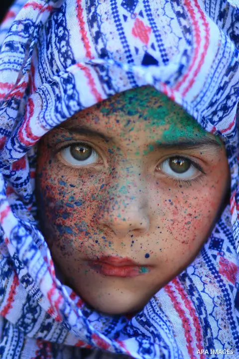Cropped portrait of a young girl with paint on her face. Photo by Sanad Ltefa
