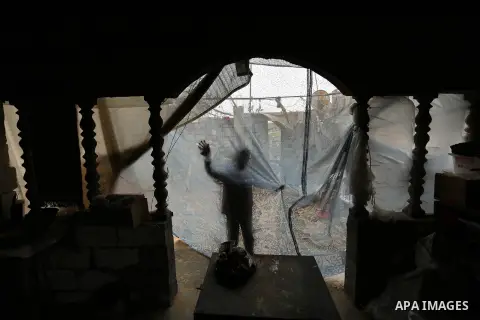 A Palestinian boy plays outside his family house on a stormy day in Khan Younis in the southern Gaza Strip January 5, 2018. Palestinian department of Meteorology warned people against gusty winds that could reach 90 km/h...