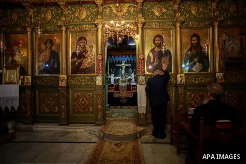 Palestinian Greek Orthodox Christians attend Christmas mass at the Orthodox Saint Porfirios church in Gaza City on January 7, 2018. The Orthodox Church celebrates Christmas and other religious holidays according to the J...