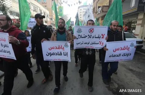 Palestinians hold national flags during a protest against U.S. President Donald Trump's decision to recognise Jerusalem as the capital of Israel, in Gaza city on January 9, 2018. Photo by Mohammed Asad