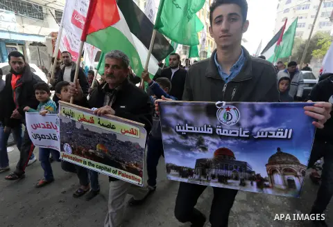Palestinians hold national flags during a protest against U.S. President Donald Trump's decision to recognise Jerusalem as the capital of Israel, in Gaza city on January 9, 2018. Photo by Mohammed Asad