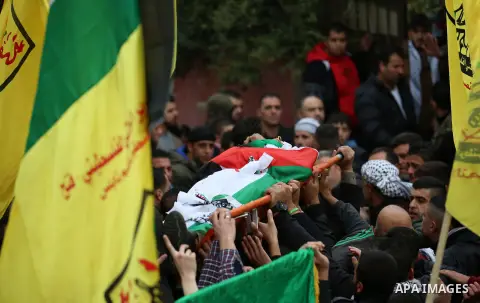 Palestinian mourners carry the body of Ali Omar Qino, 16, during his funeral at the village of Burin near the West Bank city of Nablus, on January 12, 2018. Two Palestinian teenagers were shot dead in clashes with Israel...