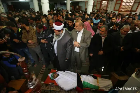 Palestinians pray over the body of Abdullah Zeidan, a 33-year-old fisherman at the mosque, in Gaza City on January 13, 2018. A fisherman from the Gaza Strip was shot dead by the Egyptian army overnight for unclear reason...