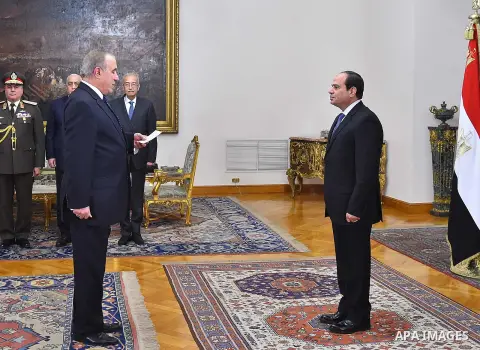 Egyptian President Abdel-Fattah el-Sissi, right, listens to the new ministers during a swearing-in ceremony for new cabinet ministers, in Cairo, Egypt, on January 14, 2018. Photo by Egyptian President Office