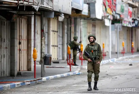 Israeli security forces take position during clashes with Palestinian protesters in the city of Hebron in the occupied West Bank, on January 23, 2018, as protests erupted following US Vice Presidents reaffirmation of US...