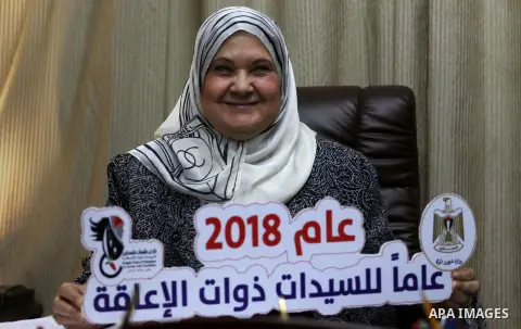 Palestinian minister of woman's Affairs, Haifa Al-Agha, meets with disabilities women at her office, in Gaza city on January 28, 2018. Photo by Mohammed Asad