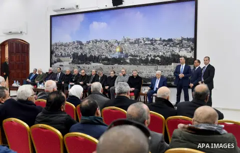 Palestinian President Mahmoud Abbas receives condolences of Ghassan Shakaa, a member of the Executive Committee of the PLO at his headquarters in the West Bank city of Ramallah on January 30, 2018. Photo by Osama Falah