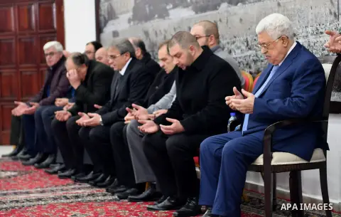 Palestinian President Mahmoud Abbas receives condolences of Ghassan Shakaa, a member of the Executive Committee of the PLO at his headquarters in the West Bank city of Ramallah on January 30, 2018. Photo by Osama Falah