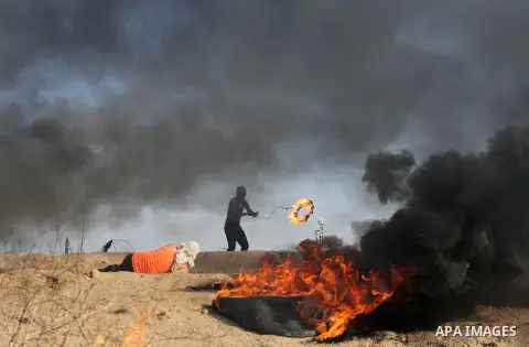 Palestinian protesters clash with Israeli security forces, against US President Donald Trump's decision to recognise Jerusalem as the capital of Israel, near the border with Israel in the southern Gaza Strip on February...