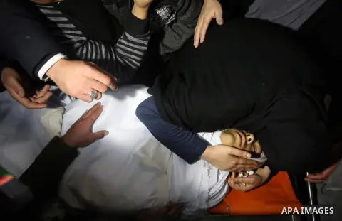 Relatives of Palestinian Ahmed Abu Obeid, 19, who was shot dead during clashes with Israeli security foces mourn over his body at a hospital morgue, in the West Bank city of Jenin, on February. 03, 2018. Photo by Shadi J...