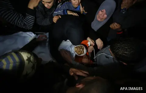 Relatives of Palestinian Ahmed Abu Obeid, 19, who was shot dead during clashes with Israeli security foces mourn over his body at a hospital morgue, in the West Bank city of Jenin, on February. 03, 2018. Photo by Shadi J...