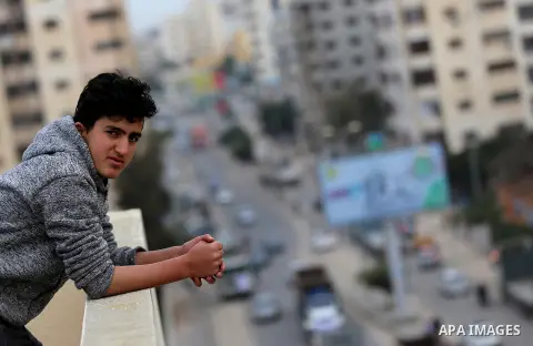 A Palestinian boy looks as truck drivers take part in a protest against the siege on the Gaza Strip, on February 6, 2018 in Gaza City. Israel has maintained a siege on Gaza for a decade which it says is necessary to limi...