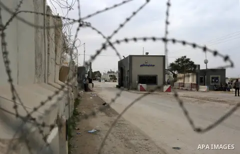 Palestinian security men stand outside Kerem Shalom, the main passage point for goods entering Gaza, in the southern Gaza Strip town of Rafah on February 6, 2018. Israel has maintained a siege on Gaza for a decade which...
