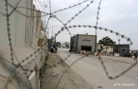 Palestinian security men stand outside Kerem Shalom, the main passage point for goods entering Gaza, in the southern Gaza Strip town of Rafah on February 6, 2018. Israel has maintained a siege on Gaza for a decade which...