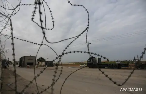 Palestinian security men stand outside Kerem Shalom, the main passage point for goods entering Gaza, in the southern Gaza Strip town of Rafah on February 6, 2018. Israel has maintained a siege on Gaza for a decade which...