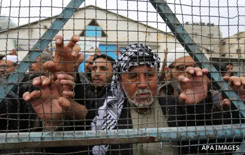 Palestinians take part in a protest against the US move to freeze funding for the UN agency for Palestinian refugees in the southern Gaza Strip town of Rafah on February 6, 2018. Photo by Ashraf Amra
