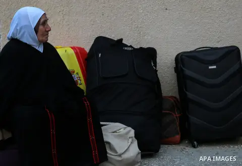 Palestinians wait for travel permits to cross into Egypt through the Rafah border crossing after it was opened by Egyptian authorities for humanitarian cases on the first time in 2018, in the southern Gaza Strip on Febru...
