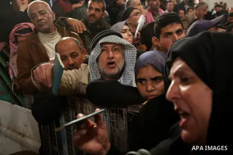 Palestinians wait for travel permits to cross into Egypt through the Rafah border crossing after it was opened by Egyptian authorities for humanitarian cases on the first time in 2018, in the southern Gaza Strip on Febru...