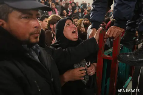 Palestinians wait for travel permits to cross into Egypt through the Rafah border crossing after it was opened by Egyptian authorities for humanitarian cases on the first time in 2018, in the southern Gaza Strip on Febru...
