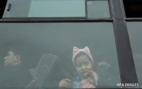 Palestinians wait for travel permits to cross into Egypt through the Rafah border crossing after it was opened by Egyptian authorities for humanitarian cases on the first time in 2018, in the southern Gaza Strip on Febru...