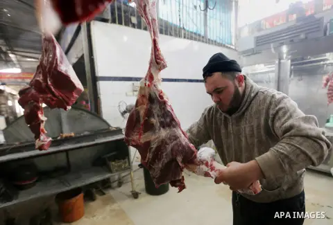 A Palestinian butcher cuts meat at a market in Gaza city on February 8, 2018. Last two days, chicken prices in Gaza strip soared to a record high, to reach to 5$ per 1 Kg. The ongoing economic crisis in the Gaza Strip co...