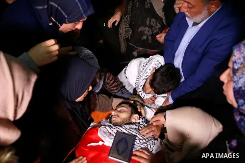 Relatives of Palestinian Hamza Zamareh mourn over his body during hid funeral in Halhoul, in the West Bank city of Hebron on February 17, 2018. Hamza stabbed a security guard at the entrance of the Israeli settlement Kar...