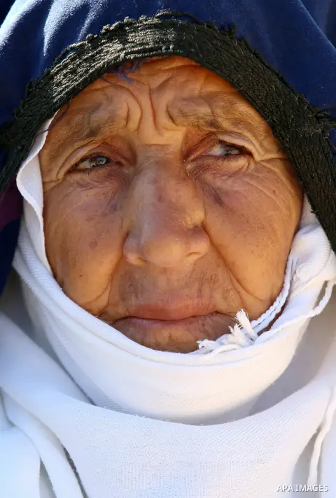 An elderly Palestinian woman Sobha Kassab 77, wears a traditional cloak or "Abaya" outside her house in the West Bank village of Qaryut, near Nablus on February 21, 2018. Decades ago, the cloack or "Abaya" was common for...