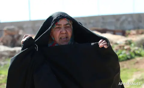 An elderly Palestinian woman Nada Auda 62, wears a traditional cloak or "Abaya" outside her house in the West Bank village of Qusra, near Nablus on February 21, 2018. Decades ago, the cloack or "Abaya" was common for vil...