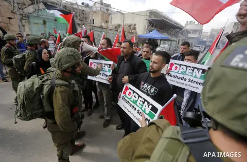 Palestinians clash with Israeli troops following a demonstration against the closure of Shuhada street, on the 24th anniversary of the closure, on February 23, 2018 in the West Bank city of Hebron. On February 25, 1994 I...