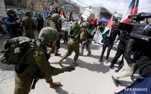 Palestinians clash with Israeli troops following a demonstration against the closure of Shuhada street, on the 24th anniversary of the closure, on February 23, 2018 in the West Bank city of Hebron. On February 25, 1994 I...