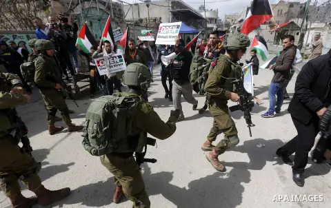 Palestinians clash with Israeli troops following a demonstration against the closure of Shuhada street, on the 24th anniversary of the closure, on February 23, 2018 in the West Bank city of Hebron. On February 25, 1994 I...