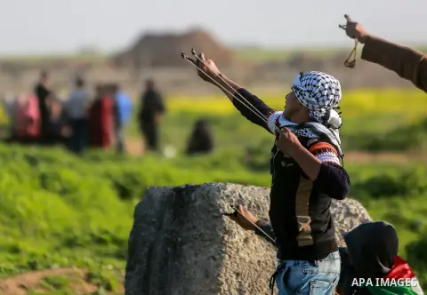 Palestinian protesters clash with Israeli security forces near the border fence with Israel, east of Gaza City on February 23, 2018. Photo by Mohammed Dahman