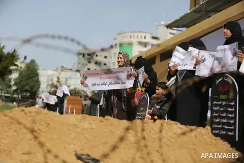 Palestinian women hold banners during a protest against the siege on the Gaza Strip in Gaza City on February 25, 2018. Israel has maintained a siege on Gaza for a decade which it says is necessary to limit Hamas, the Isl...