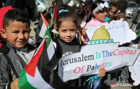 Palestinian children hold banners during a protest against U.S. President Donald Trump's decision to recognise Jerusalem as the capital of Israel, in front of the high commissioner for human rights headquarters, in Gaza...