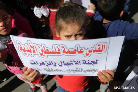 Palestinian children hold banners during a protest against U.S. President Donald Trump's decision to recognise Jerusalem as the capital of Israel, in front of the high commissioner for human rights headquarters, in Gaza...