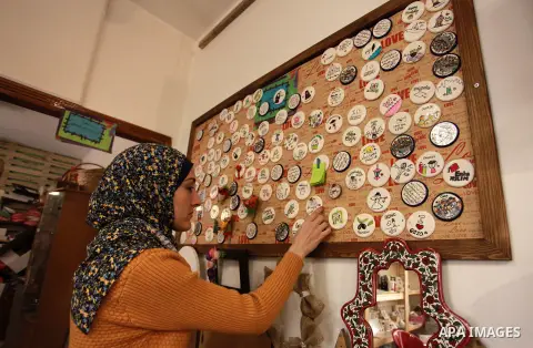 A Palestinian artist Dima Sha'sha'a "owner of Tezzkar Project" works at her shop in Gaza city on February 28, 2018. Dima and her brother Hamdi take the drawing on dishes, cardboard and glass as a job for nearly seven yea...