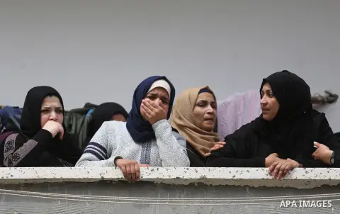 Relatives of Ismail Abu Riyala, a young Palestinian fisherman, mourn during his funeral in Gaza City on March 15, 2018, two weeks after he was killed in a disputed incident. Israel argued his boat had strayed outside Gaz...