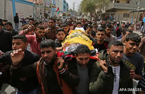 Palestinian mourners carry the body of Ismail Abu Riyala, a young Palestinian fisherman, during his funeral in Gaza City on March 15, 2018, two weeks after he was killed in a disputed incident. Israel argued his boat had...