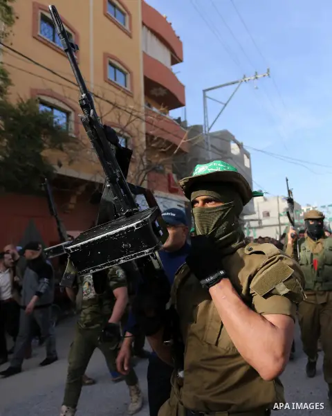 Mourners carry the body of a member of Palestinian security forces loyal to Hamas during his funeral in the central Gaza Strip March 22, 2018. Photo by Ashraf Amra