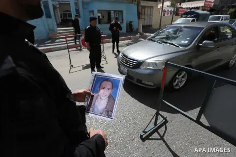 Palstinian policemen inspect the trunk of a car at a checkpoint as they tighten security around Gaza city, on March 22, 2018 Hamas has named a fugitive suspect in a bomb attack on Palestinian prime minister Rami Hamdalla...