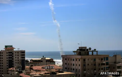 The smoke of a rocket fired by Palestinian Hamas militants is seen over Gaza City on March 25, 2018 as they take part in a military drill. Photo by Dawoud Abo Alkas