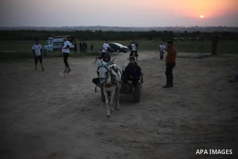 Paleatinians gather next to tents pitched by Palestinians on the Gaza border with Israel, east of Jabalia, on March 29, 2018, ahead of a six-week protest camp. The exceptional protest is dubbed "The Great March of Return...
