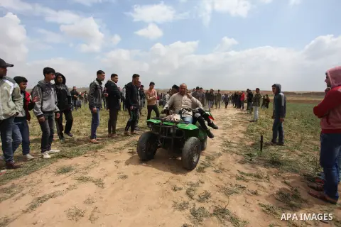 A wounded Palestinian is evacuated during clashes with Israeli security forces, during a tent city protest along the Israel border with Gaza, demanding the right to return to their homeland, east of Jabalia, in the north...