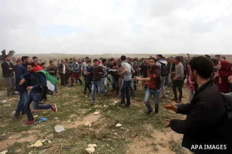 A wounded Palestinian is evacuated during clashes with Israeli security forces, during a tent city protest along the Israel border with Gaza, demanding the right to return to their homeland, east of Jabalia, in the north...