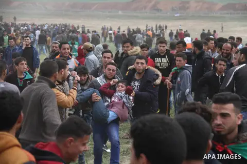 A wounded Palestinian is evacuated during clashes with Israeli security forces, during a tent city protest along the Israel border with Gaza, demanding the right to return to their homeland, east of Jabalia, in the north...
